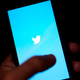 The Twitter application is seen on a digital device.